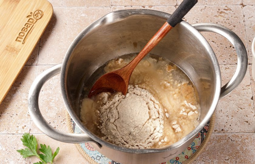 1. Этап. Диетические профитроли: Всыпьте всю муку, не снимая кастрюльку с огня.