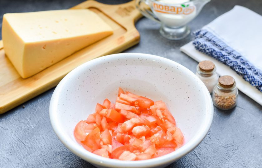 1. Этап. Салат с помидорами и курицей: Помидоры ополосните и просушите, нарежьте томаты небольшими кубиками, переложите в миску.