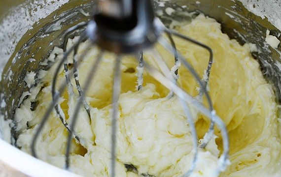 1. Этап. Тыквенные булочки с корицей и орехами: 8. С помощью миксера взбейте сливочный сыр, 1/4 стакана молока, сахарную пудру и 2 столовые ложки сливочного масла. Взбейте пышный крем.