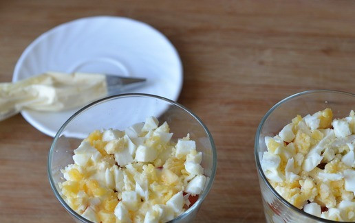 1. Этап. Салат Восторг: Следующим слоем кладём порезанные или тёртые вареные яйца, смазываем майонезом с чесноком.