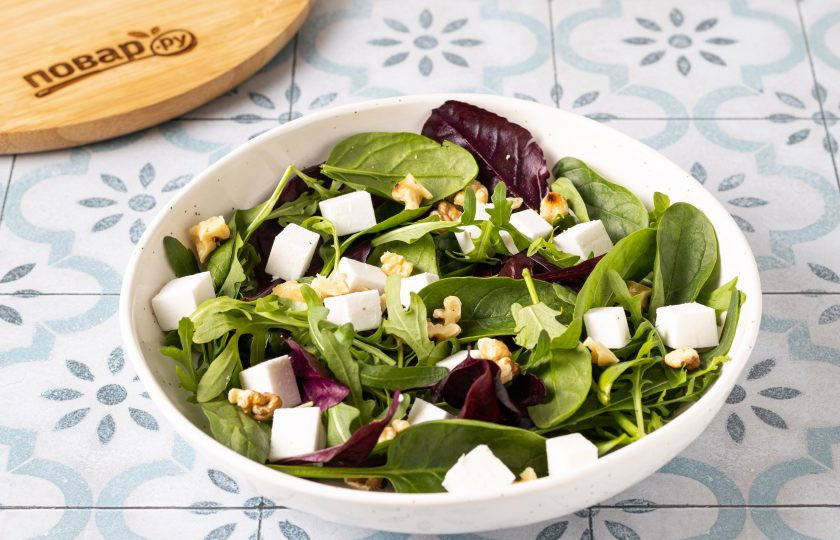 1. Этап. Салат со шпинатом, малиной и фетой: Выложите в тарелку к салатным листьям фету и грецкие орехи.