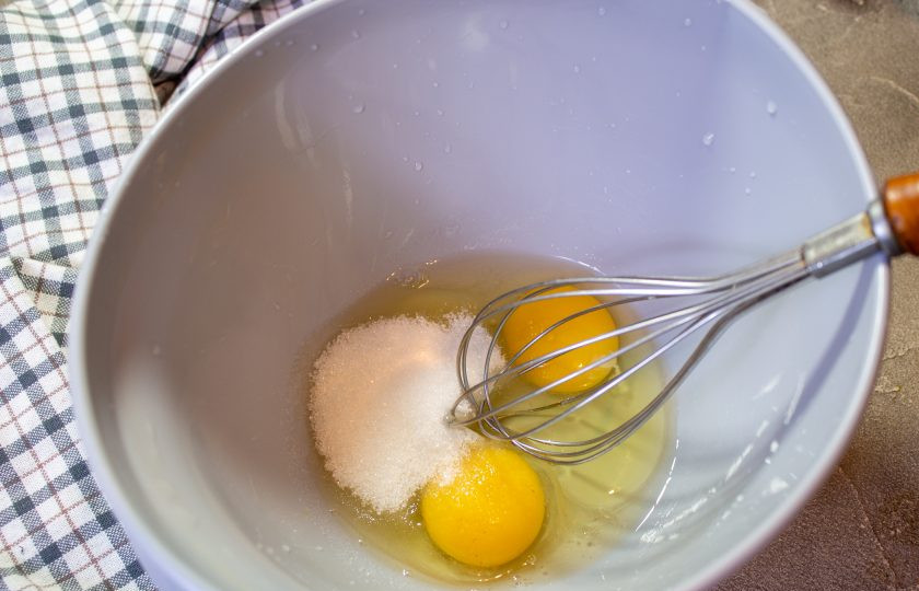 1. Этап. Морковный кекс с орехами: В миску вбейте куриные яйца, добавьте соль и сахар. Перемешайте ингредиенты.