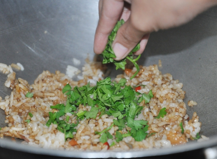 1. Этап. Рис с яйцом по-тайски: Порубите мелко кинзу и высыпьте её к овощам.