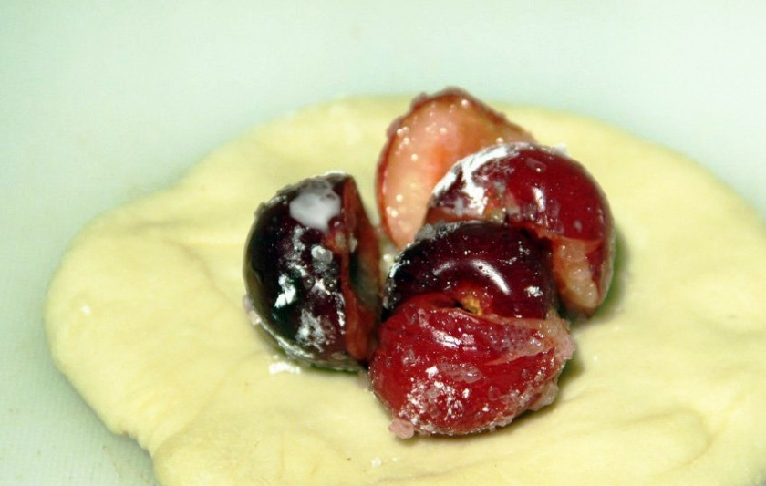 1. Этап. Вишневые булочки: Тесто разделите на равные части, раскатайте и выложите в центр каждой лепешки часть начинки. Защипните края и сформируйте булочку.