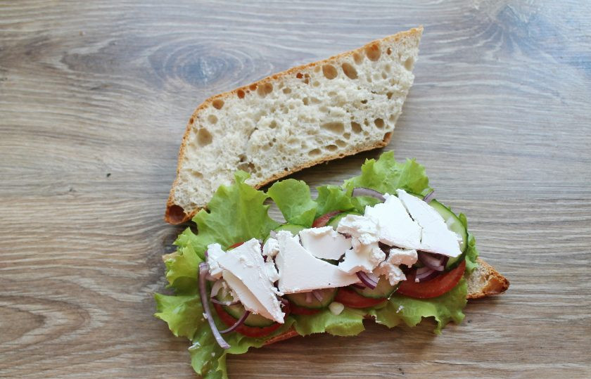 1. Этап. Греческий сэндвич: Брынзу порежьте на пластинки и выложите на порезанный красный лук.