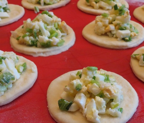 1. Этап. Пирожки с рисом и яйцом: 5. Когда тесто готово, можно приступать к основному процессу. Отделить небольшой кусочек теста и размять руками, формируя небольшой кружочек. В середину выложить начинку и аккуратно залепить края. Таким образом поступить со всеми пирожками. Чтобы легче было работать с тестом, можно смазать руки небольшим количеством растительного масла.