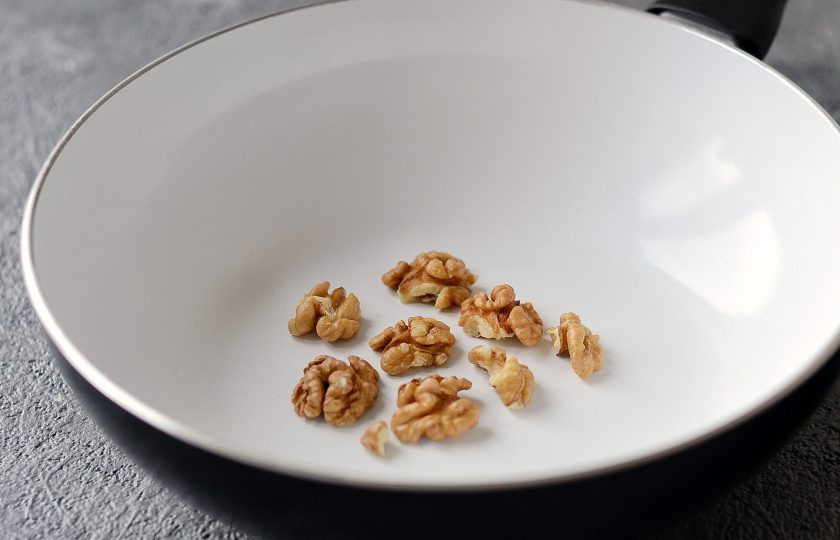 1. Этап. Салат со шпинатом, орехами и гранатом: Грецкие орехи крупно порубите, затем подсушите на сковороде до появления аромата.