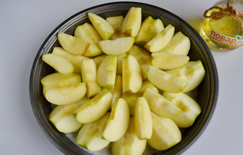 1. Этап. Яблочный пирог Татьяны Толстой: 4. Оставшиеся яблоки порежьте дольками и уложите сверху. Посыпьте второй половиной стакана сахара и отправьте в духовку, температура 220 градусов, запекайте яблоки до мягкости.