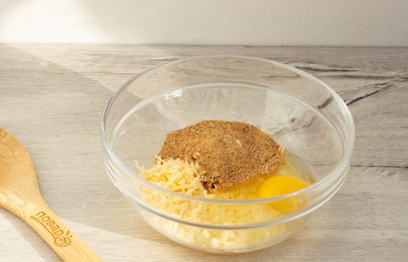 1. Этап. Куриный суп с сырными фрикадельками: Сыр натрите на мелкой терке. Добавьте к сыру сырое яйцо и постепенно всыпайте панировочные сухари, пока масса не станет тестообразной.