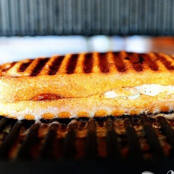 1. Этап. Панини с курицей и беконом: 7. Поместить в гриль для панини и обжарить до золотисто-коричневого цвета. Если у вас нет гриля для панини, вы можете обжарить панини в обычной сковороде, придавив верхушку панини каким-либо предметом, например, тяжелой крышкой. Таким же образом обжарить панини с другой стороны.