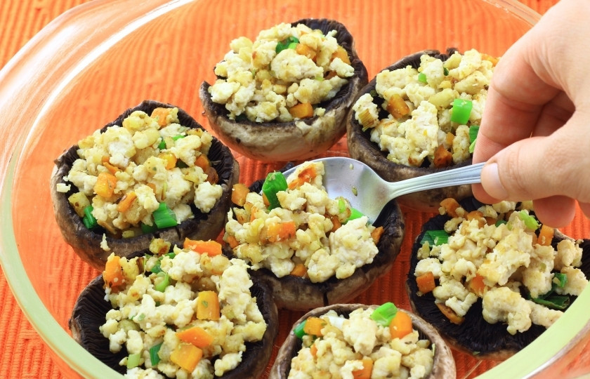 1. Этап. Салат Русская красавица с грибами: Посолите, поперчите начинку по вкусу. И столовой ложкой выкладывайте в грибные шляпки. Если грибные шляпки не достаточно полые, чайной ложечкой выскребите больше мякоти. Укладывайте начинённые грибные шляпки в форму для выпекания.