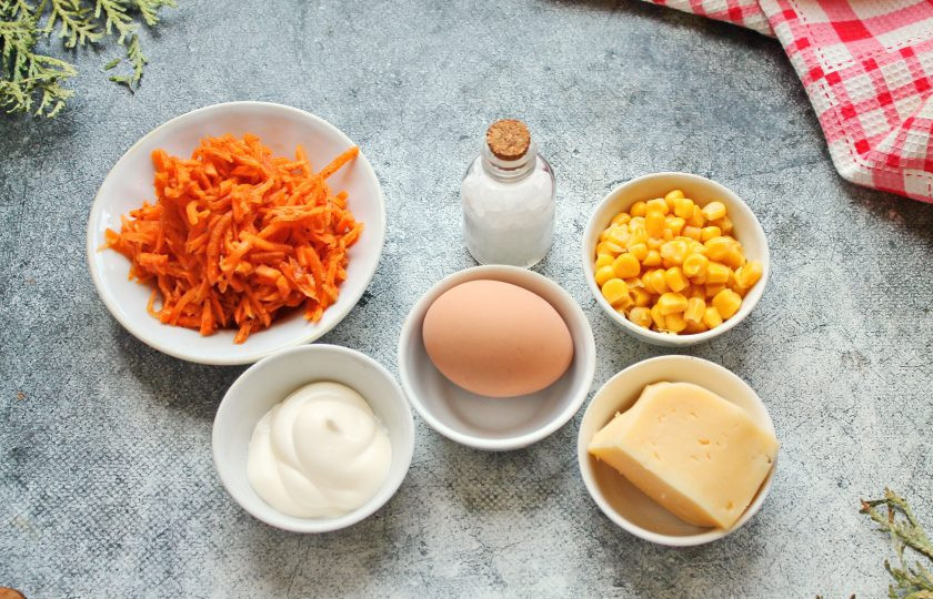 1. Этап. Салат с сыром, кукурузой и морковью: Подготовьте все необходимые ингредиенты для приготовления салата с сыром, кукурузой и морковью. С кукурузы и моркови по-корейски слейте жидкость.