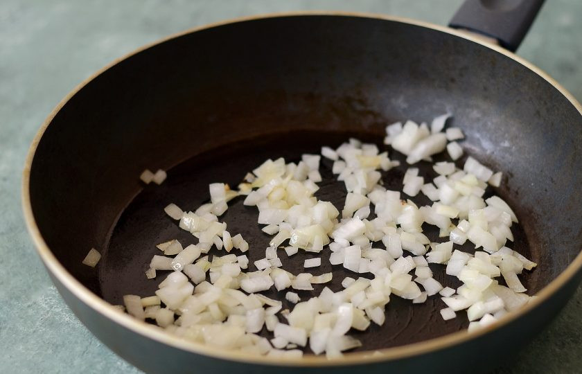 1. Этап. Котлеты из тыквы на пару: Лук нарежьте кубиками, обжарьте в сковороде до золотистого цвета.