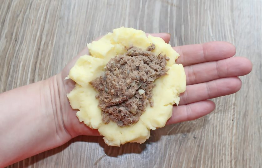 1. Этап. Зразы с ливером: Влажными руками из каждого шарика сделайте лепешку и выложите начинку из ливера. Затем соедините края и сформируйте плотные зразы.