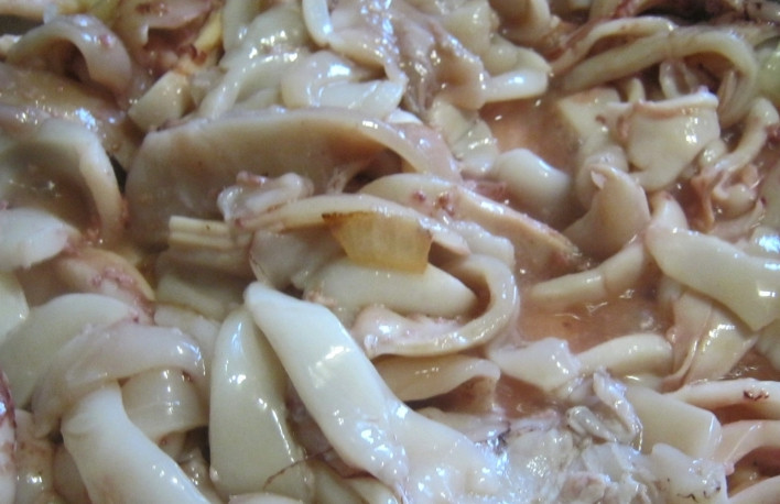 1. Этап. Паста с кальмарами в сливочном соусе: Репчатый лук избавьте от шелухи и нарежьте его мелкими кусочками. На сливочном масле обжарьте лук до прозрачного состояния. В эту же сковороду добавьте сливки и сметану. В этот соус добавьте щепотку мускатного ореха, соль и перец по вкусу. Теперь в этот соус положите кальмары и протушите его пять минут.