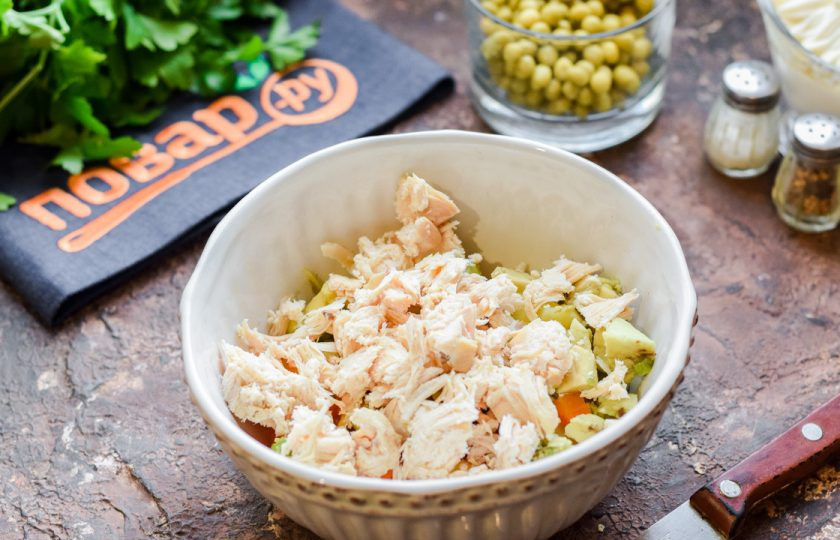 1. Этап. Оливье с курицей и авокадо: Вареное филе нарежьте небольшими кубиками и добавьте в салат.