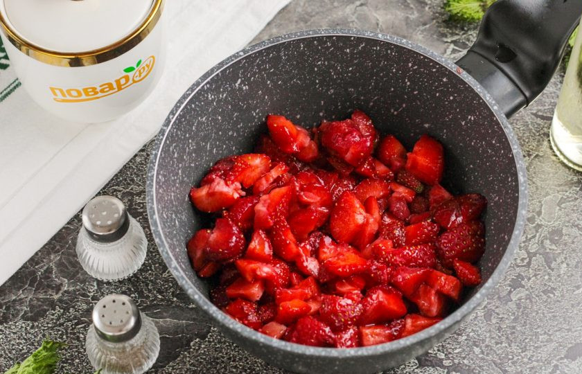 1. Этап. Соус из клубники к мясу: Клубнику промойте в воде и удалите хвостики. Нарежьте ягоды мелкими кубиками и выложите их в казан или сотейник, ковш.