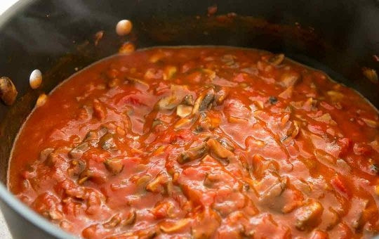 1. Этап. Лазанья простая: Через 5 минут введите половину томатной пасты, измельченный чеснок, воду, сахар. Тушите все 20 минут.