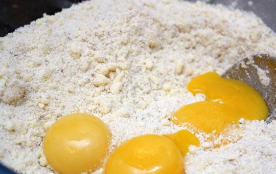 1. Этап. Будайский творожник: Добавляем в смесь 3 яичных желтка и очень быстро замешиваем тесто для творожника.