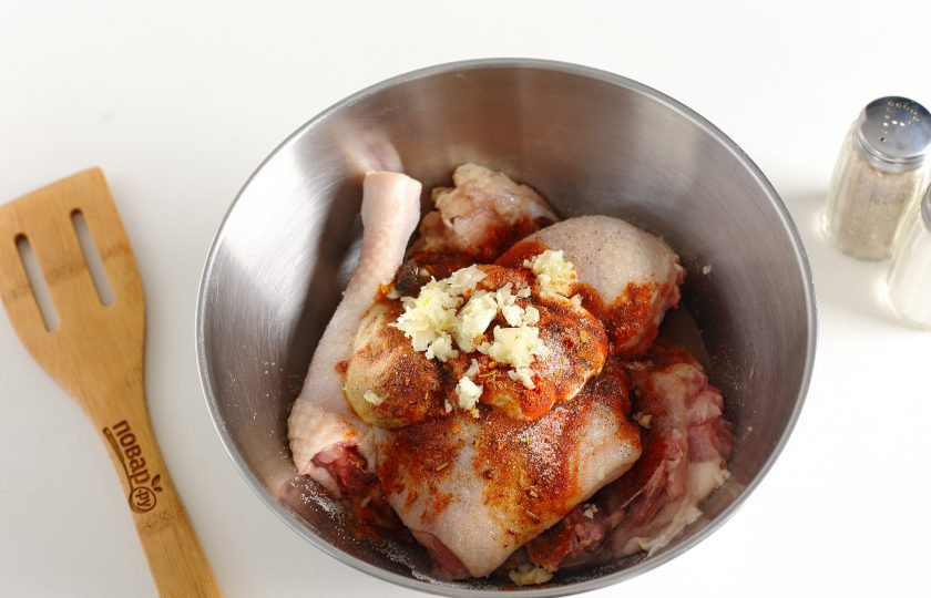 1. Этап. Курица в духовке с корочкой: Добавьте все ингредиенты для маринада: давленый чеснок, майонез, аджику, горчицу и масло. Посолите, добавьте любимые специи и все хорошо перемешайте.