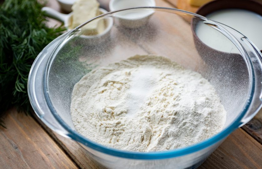 1. Этап. Хачапури на молоке с сыром: Просейте муку в просторную миску, добавьте разрыхлитель и соль. Перемешайте.