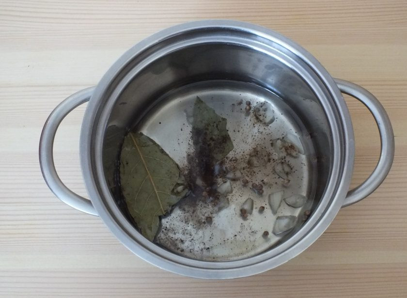 1. Этап. Салат Шахтерский с солеными огурцами: Накалите растительное масло, добавьте к нему специи, чеснок, лавровый лист.