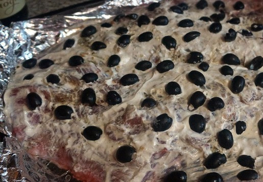 1. Этап. Сом запеченный: Выложить разрезанные пополам маслины.