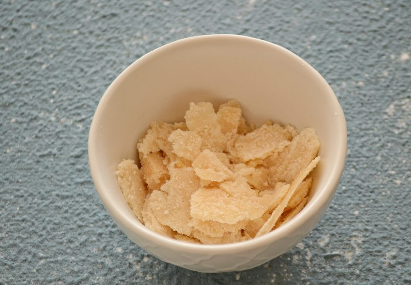 1. Этап. Салат с карамелизированной грушей: Овощечисткой нарежьте пармезан на крупные ломтики.