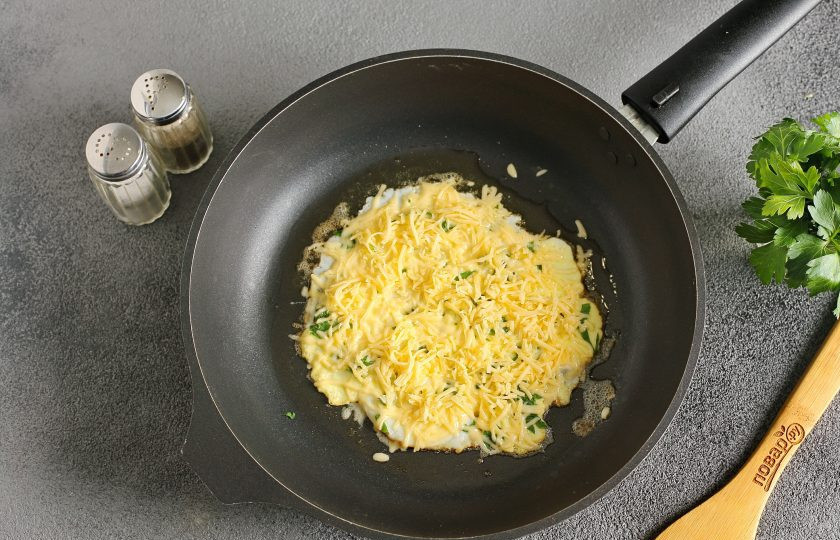 1. Этап. Португальский завтрак: Посыпьте яйцо тертым сыром.