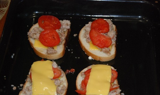 1. Этап. Горячий бутерброд По-деревенски: На сыр ровным слоем выложите фарш, затем помидор и накройте второй половинкой сыра и ломтиком батона. Отправьте противень в разогретую духовку. При 200 градусах готовится все очень быстро. Минуты через 3-4 нужно будет поставить ско0роду смазанную растительным маслом на разогрев. Через 5-7 минут нужно будет бутерброды перевернуть и отправить в духовку еще минутки на 3-4. Это даст нам хрустящий румяный хлеб. Сыр поможет бутерам не развалиться.