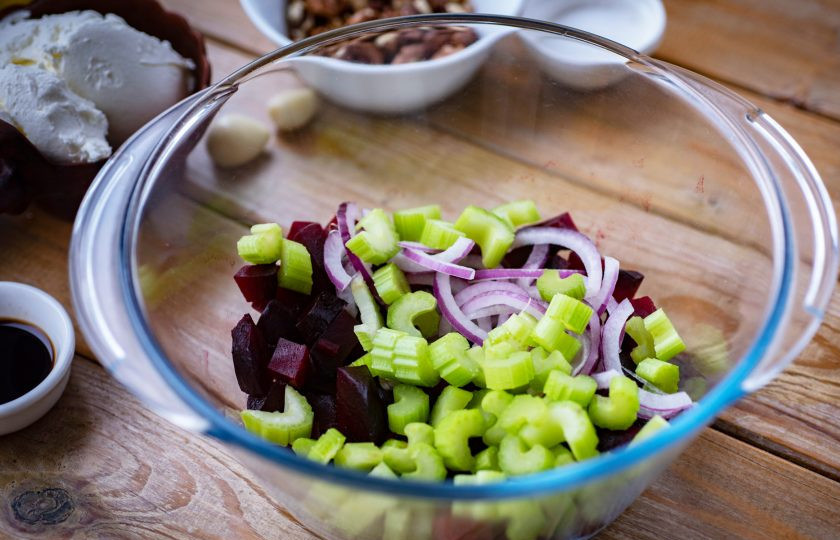 1. Этап. Салат сливочный сыр со свеклой: В просторную миску выложите кубики свеклы, нарезанные лук и сельдерей.