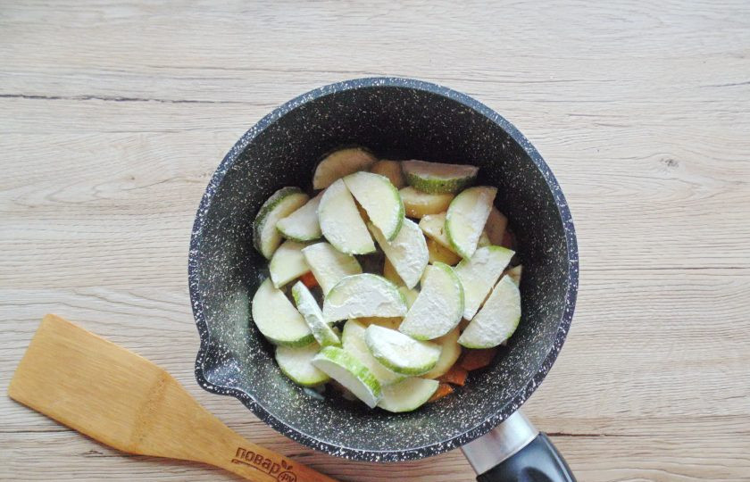 1. Этап. Соте из кабачков и помидоров: Кабачок помойте и нарежьте кружками или половиками кружков. Обваляйте в муке и выложите в кастрюлю с морковью и луком.