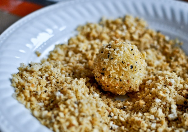 1. Этап. Шарики из пюре в сырной панировке: 4. Шарик сначала опустите в яйца, а после обваляйте в панировке.