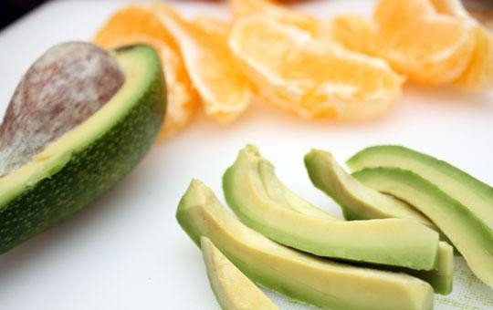 1. Этап. Салат из сладкого перца с авокадо: Авокадо очищаем от косточки и кожуры, нарезаем на тонкие и продолговатые брусочки. Апельсин аккуратно разбираем на дольки. И то, и другое выкладываем в салатницу.