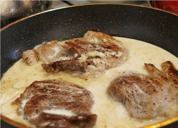 1. Этап. Мясо в чесночном соусе: Когда мясо обжарится с обеих сторон, уменьшаем огонь под сковородкой и заливаем мясо приготовленным соусом. Закрываем сковороду крышкой, тушим мясо минут 8-10.