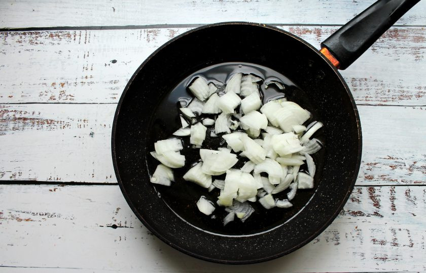 1. Этап. Солянка с жидким дымом: В сковороду налейте растительное масло, выложите нарезанный репчатый лук и обжаривайте в течение 5 минут на среднем огне.