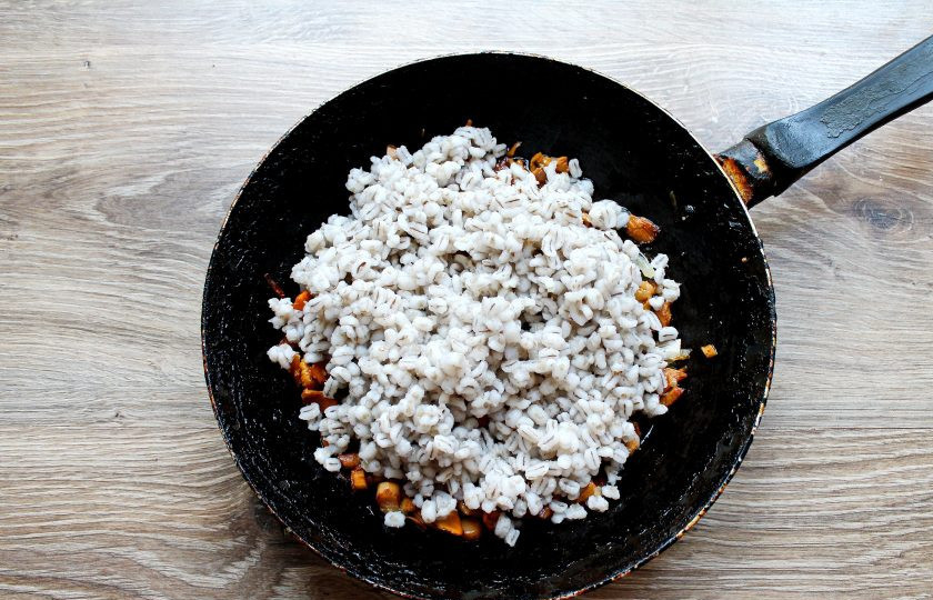 1. Этап. Перловка с лисичками: Выложите в сковороду с грибами отварную перловку, перемешайте.