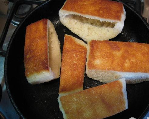 1. Этап. Яйца в гнёздах: 3. Высушиваем в духовом шкафу нарезанные и вычищенные батонные кусочки, затем их измельчаем (применять будем их в приготовлении других блюд). Кусочки батона обжариваем до появления корки оранжевого цвета.