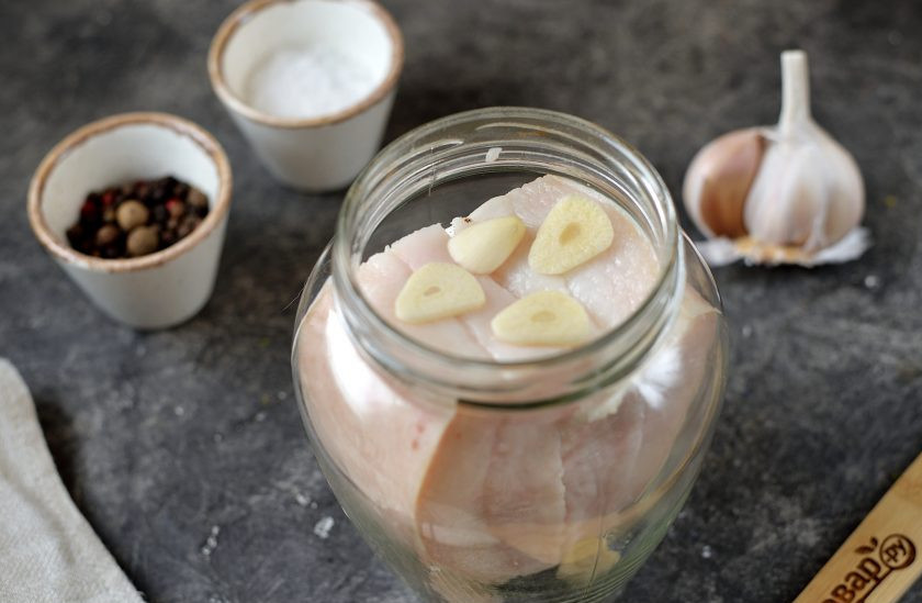 1. Этап. Сало соленое в рассоле по-деревенски: А пока почистите чеснок, нарежьте его тонкими ломтиками, нарежьте сало небольшими кусочками, выложите все в банку.