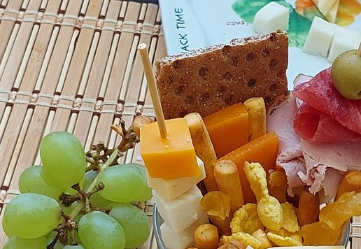 1. Этап. Фуршетный стаканчик Фруктово-сырно-мясной: Оформляем стаканчик оставшимися ингредиентами по вкусу. Удобнее сначала разместить сыр и грушу, потом крендельки и палочки. Последними - хлопья.