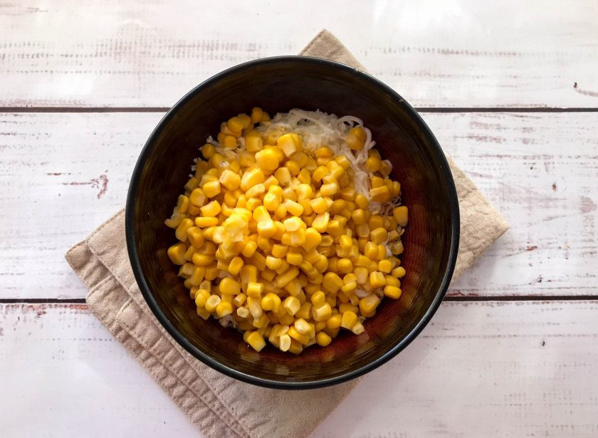 1. Этап. Салат Одуванчик с сыром: Добавьте консервированную кукурузу.