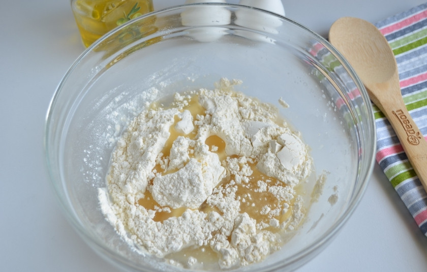 1. Этап. Беляши классические: Влейте растительное масло, всыпьте муку и замесите мягкое и пластичное тесто.