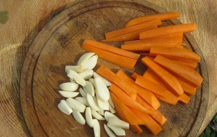 1. Этап. Буженина в аэрогриле: 3. Тем временем можно заняться морковью и второй половиной чеснока. Очищенную и вымытую морковь нарезать тонкими брусочками, чеснок - половинками.