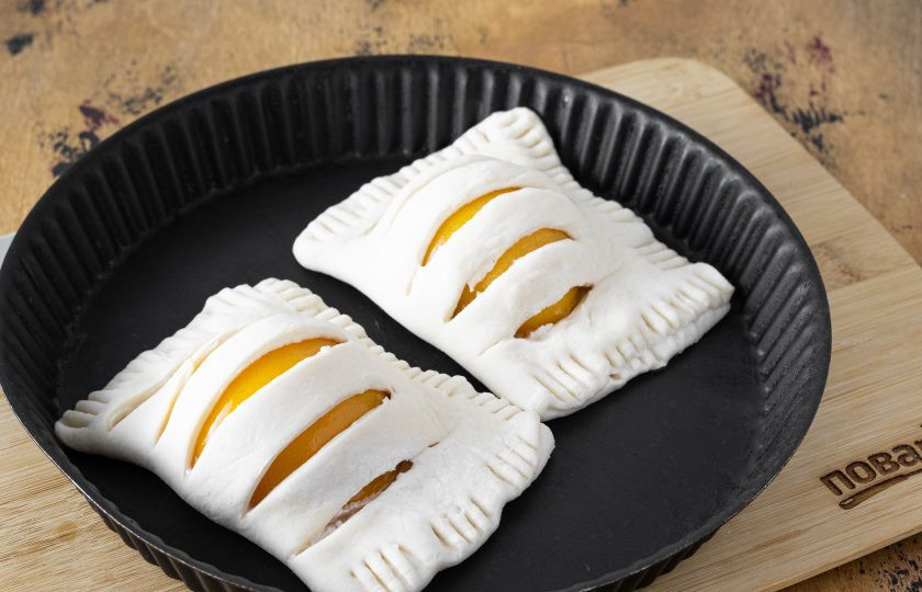 1. Этап. Слойки с консервированными персиками: По желанию смажьте слойки яйцом или растительным маслом. Выпекайте 30 минут при температуре 185 градусов. Перед подачей готовые слойки можно посыпать сахарной пудрой.