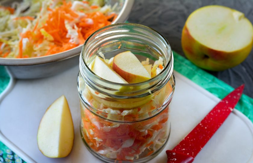 1. Этап. Квашеная капуста с морковью и яблоками: На дно чистой банки выложите специи: перец горошком и лавровый листик. Затем наполните банку капустой, перекладывая ее дольками яблок.