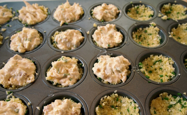 1. Этап. Закуска на новогодний корпоратив: 2. Отдельно сухари смешаем со специями, измельченной зеленью и растопленным маслом. Туда же добавим тертый пармезан, перемешаем тщательно. Эту смесь распределяем по дну формочек, сверху выкладываем крабовую пасту.