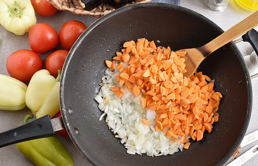 1. Этап. Икра из баклажанов на зиму: Добавьте нарезанную тонкими кусочками морковь и жарьте, помешивая, 5 минут.