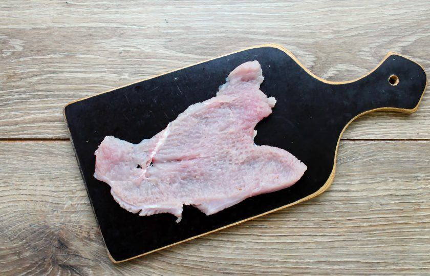 1. Этап. Рулет из индейки с яйцом в духовке: Филе индейки порежьте на пластинки толщиной 0.7 сантиметра. Филе немного отбейте, посолите и поперчите.