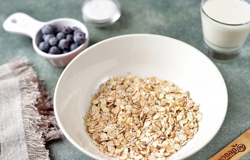 1. Этап. Каша Ассорти в микроволновке: Столовой ложкой отмерьте необходимое количество хлопьев в глубокую миску, пригодную для использования в микроволновке.