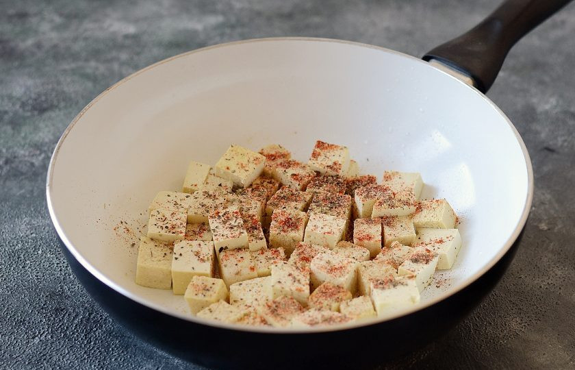 1. Этап. Рис с тофу и овощами: Тофу нарежьте кубиками. Обжарьте на сковороде со специями до румяной корочки, постоянно помешивая. Затем отложите в сторону.